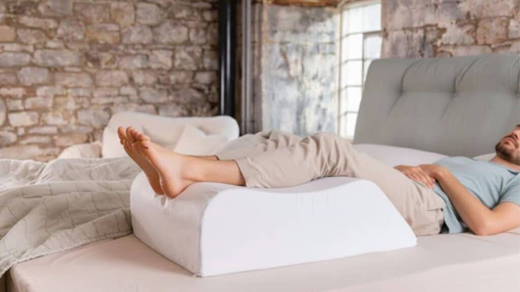 lying on back with feet elevated on a pillow