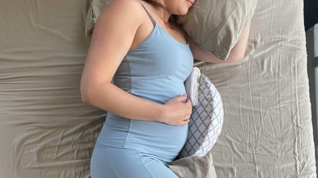 lying with a pillow under your belly pregnancy position