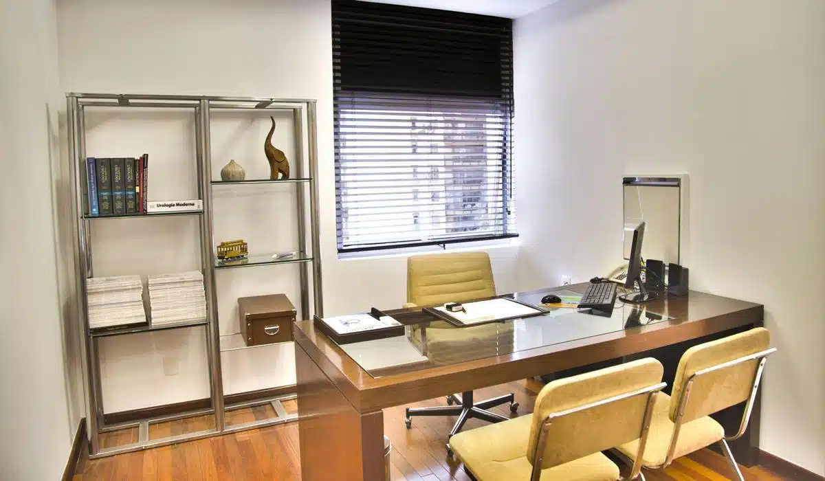 Executive office with wooden desk and glass metal shelving unit