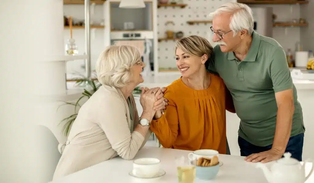 Smiling multi-generational family talking together around a kitchen table