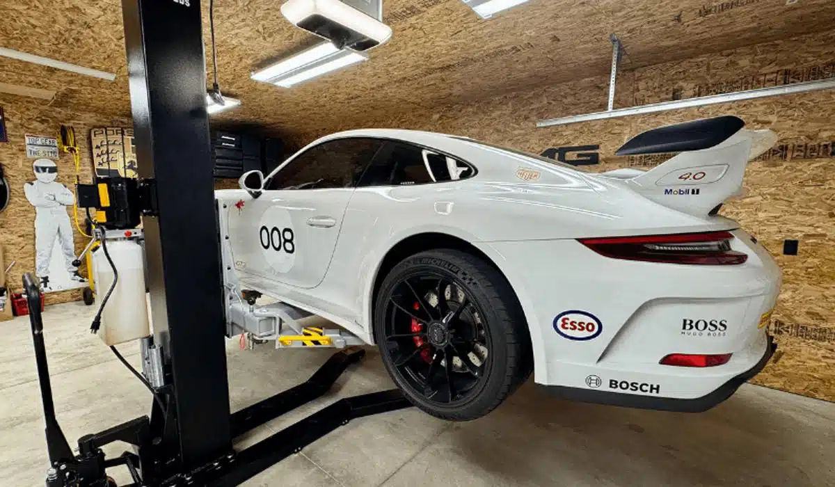 White Porsche 911 GT3 raised on single post lift