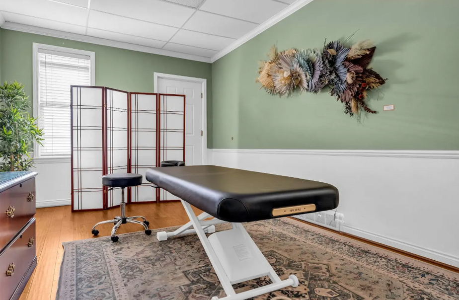 Professional massage therapy room with a table.