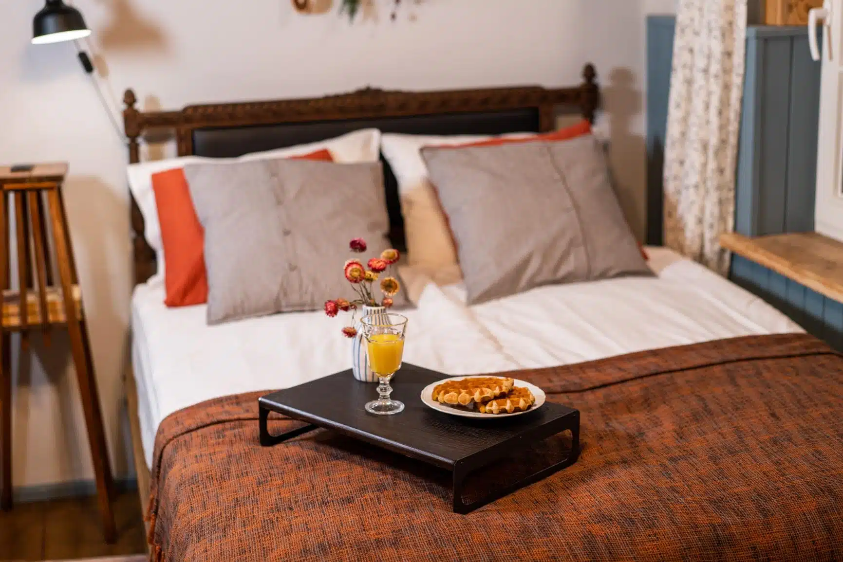 bedroom setting with bed and bed serving tray on it with breakfast