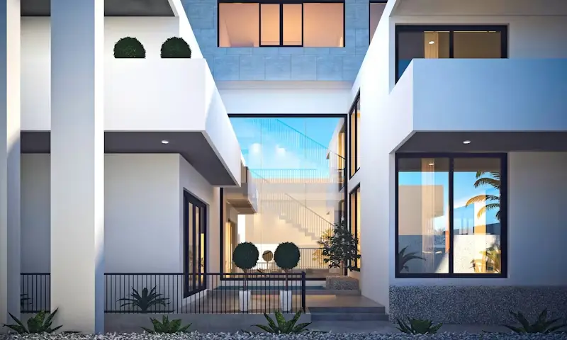 Modern courtyard with clean architectural lines, large windows, and potted plants at dusk