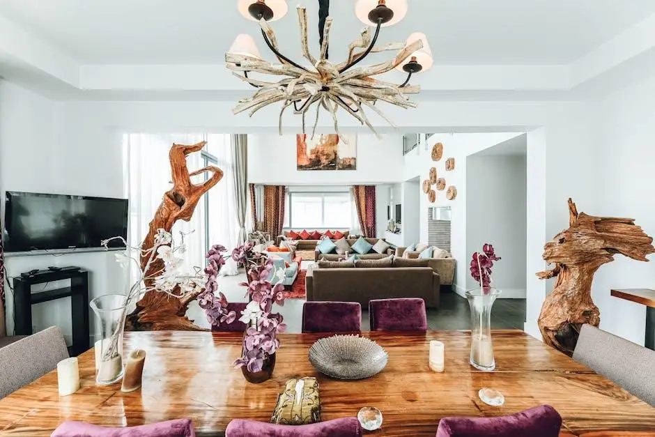 Wooden dining table with purple chairs and driftwood chandelier in modern living room setting