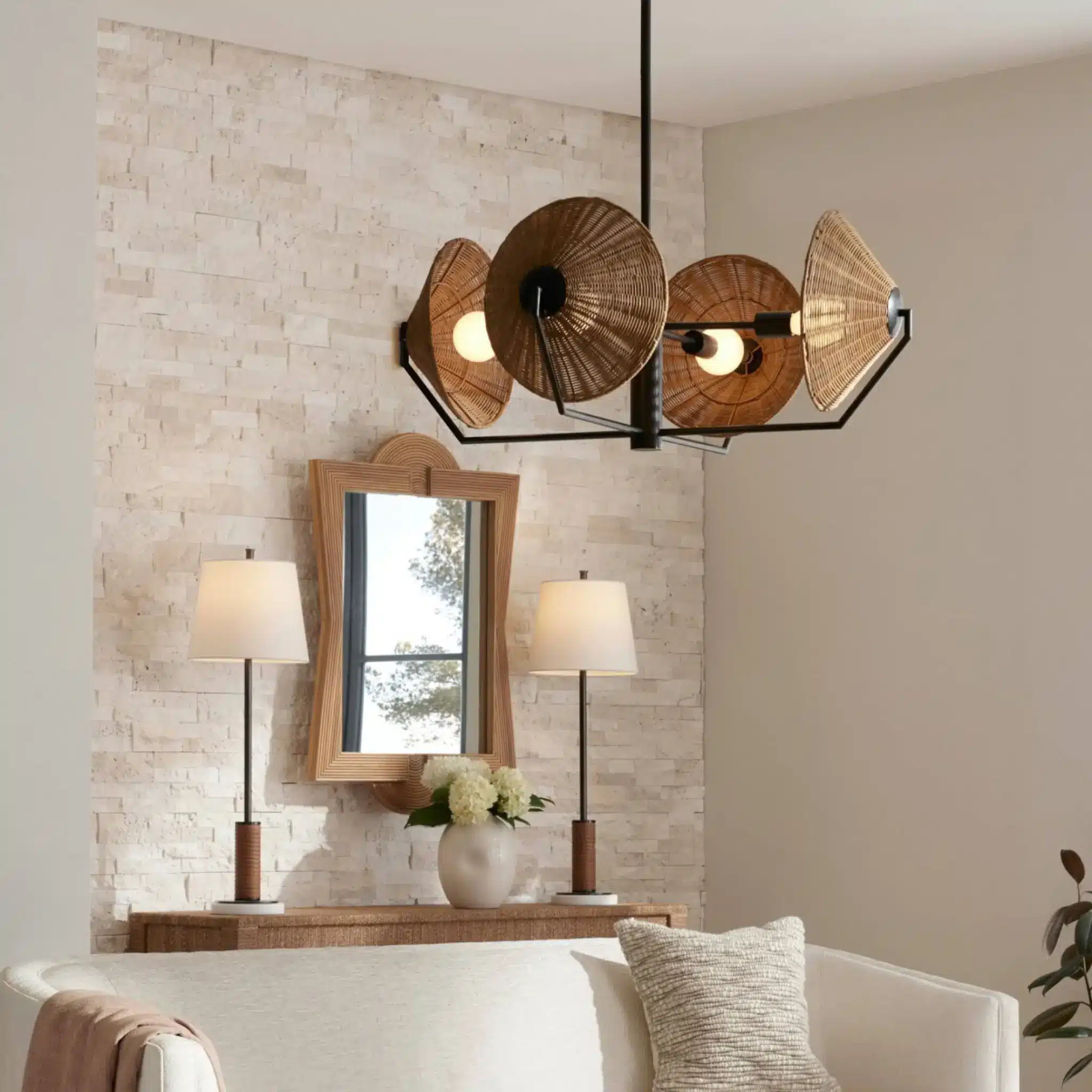 Cozy living room with woven chandelier, stone accent wall, and wooden-framed mirror above console table