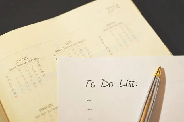 Open planner with calendar visible and pen placed on an empty to-do list page