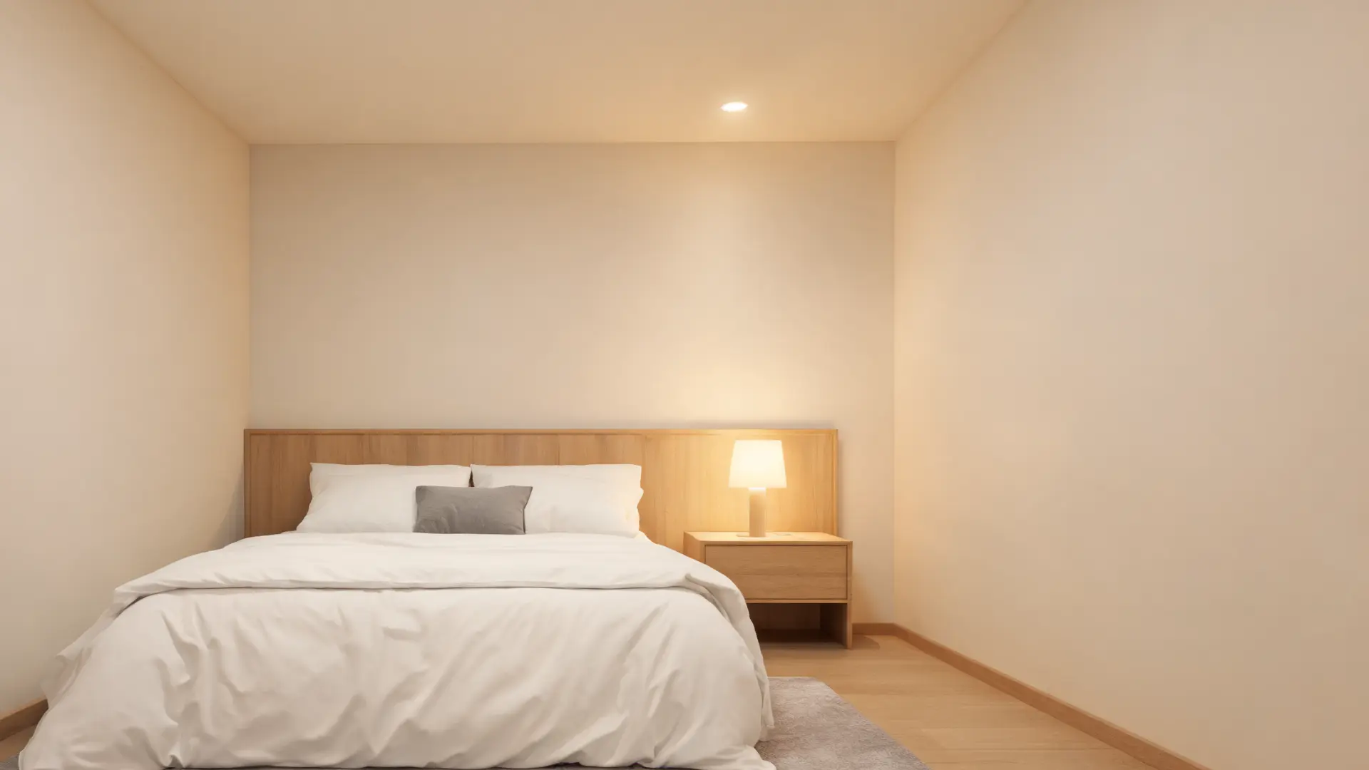 bedroom with neutral walls, cozy bedding, warm dimmable lighting, serene and balanced space