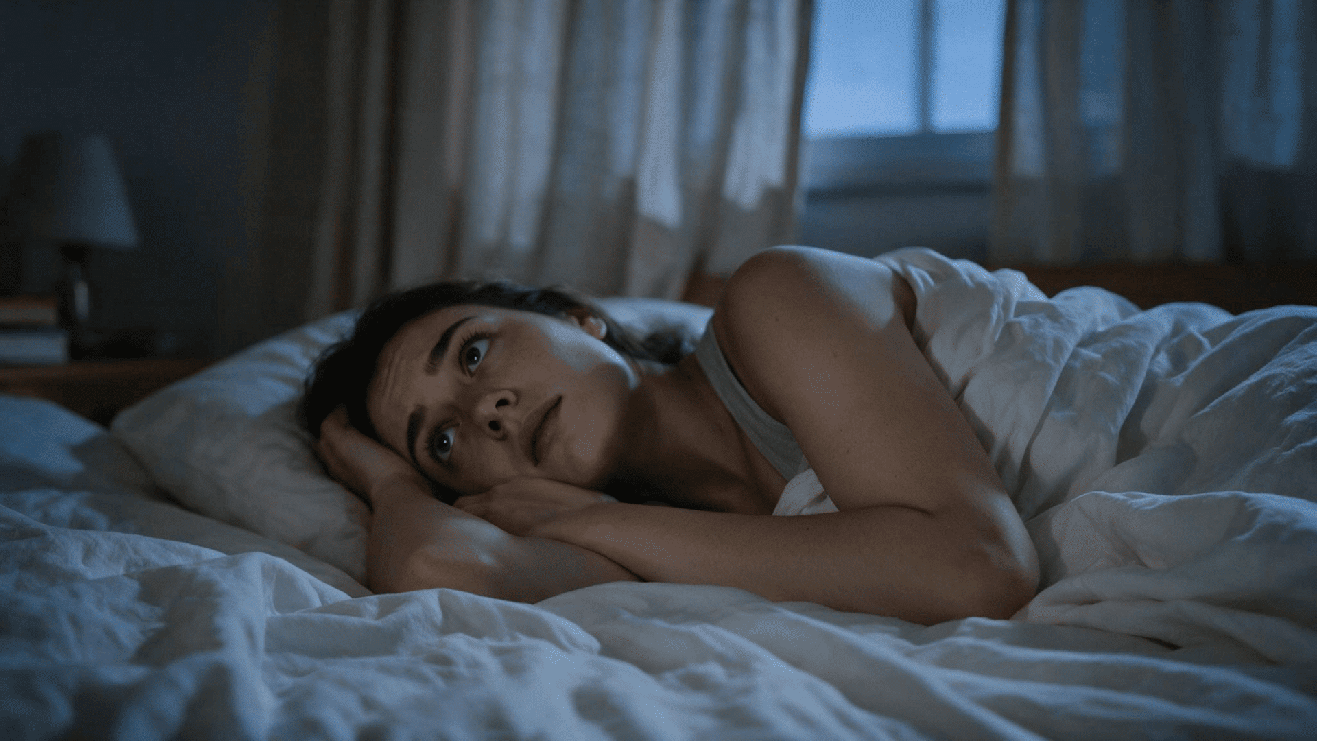 Sleepless woman awake in bed at night, unable to fall asleep