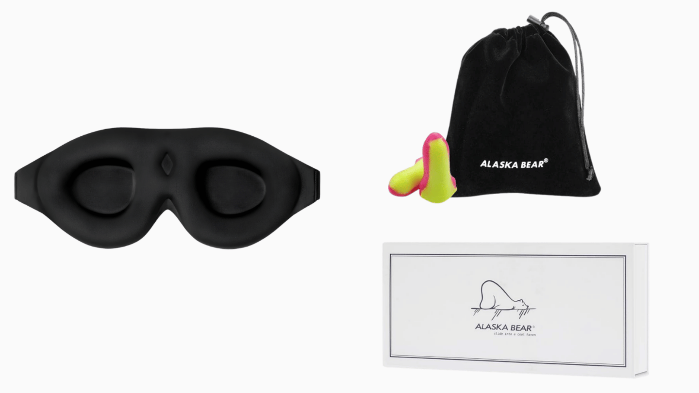 black Alaska Bear contoured sleep mask with a pouch, earplugs, and product box on a white background