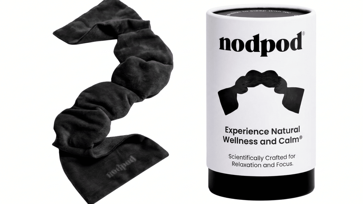 black Nodpod weighted sleep mask displayed beside its white cylindrical product box