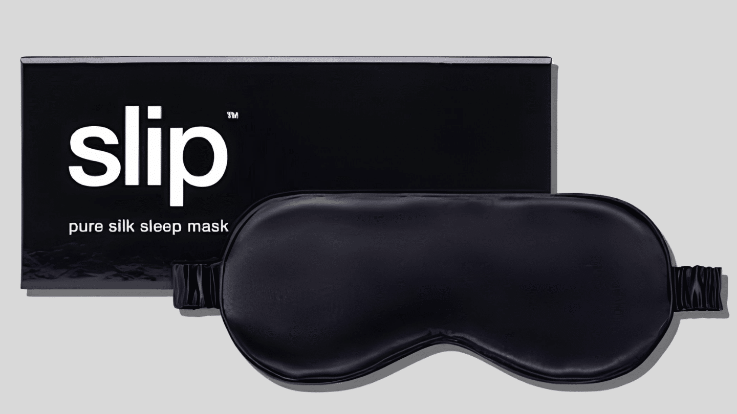 black Slip pure silk sleep mask displayed in front of its matching black product box
