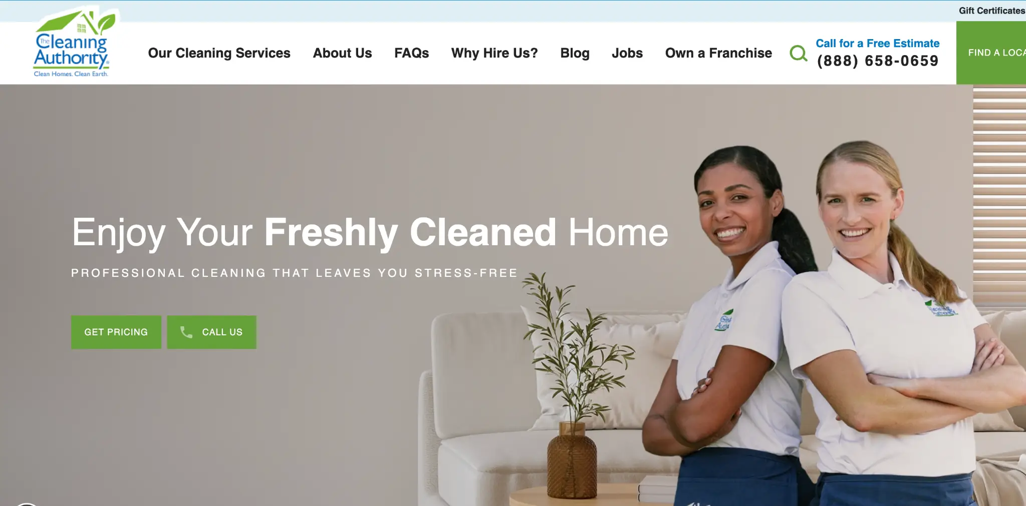 Two smiling women in uniforms standing confidently in a clean, modern living room setting