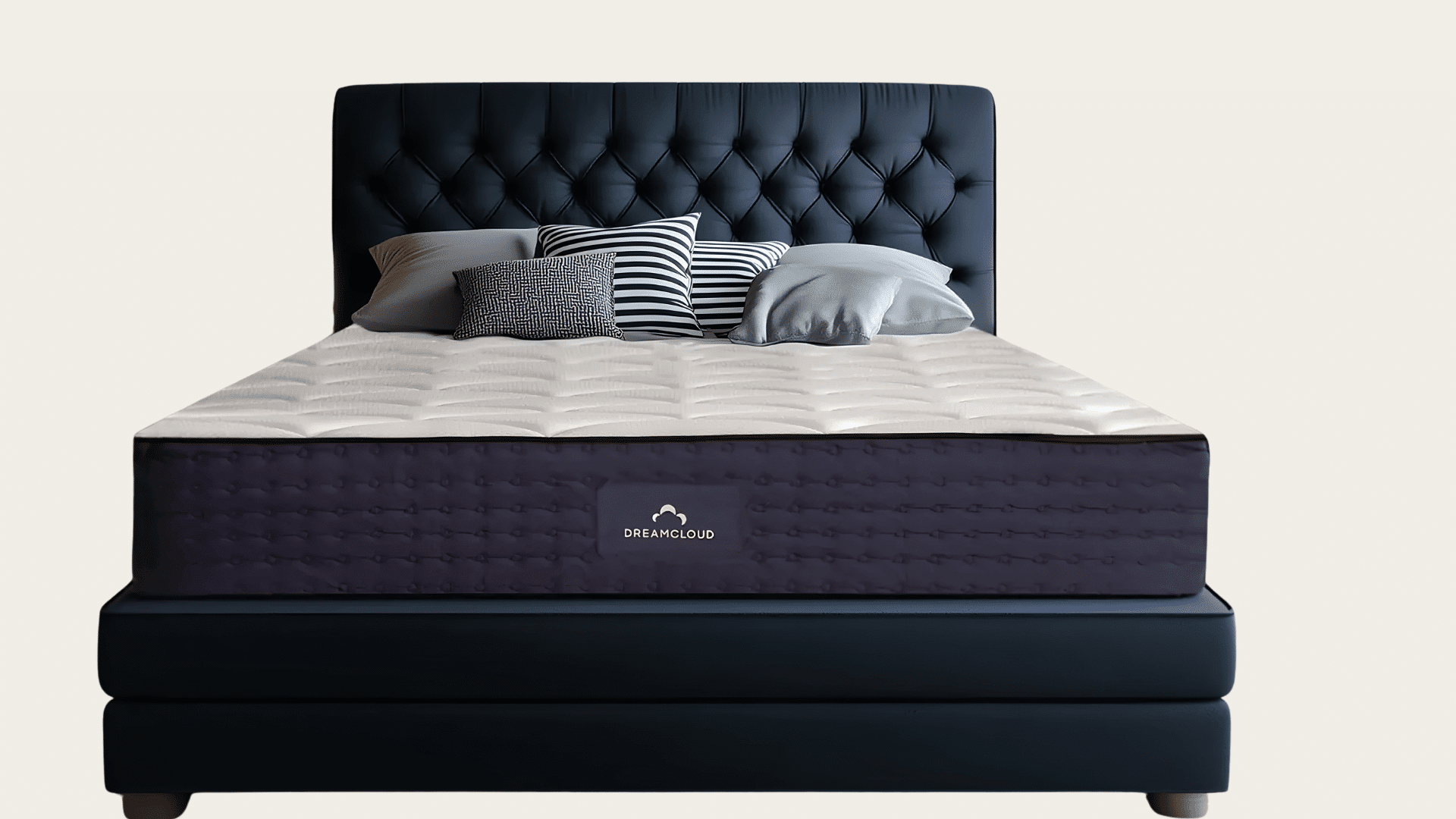 DreamCloud hybrid mattress displayed on a dark bed frame with layered comfort features.