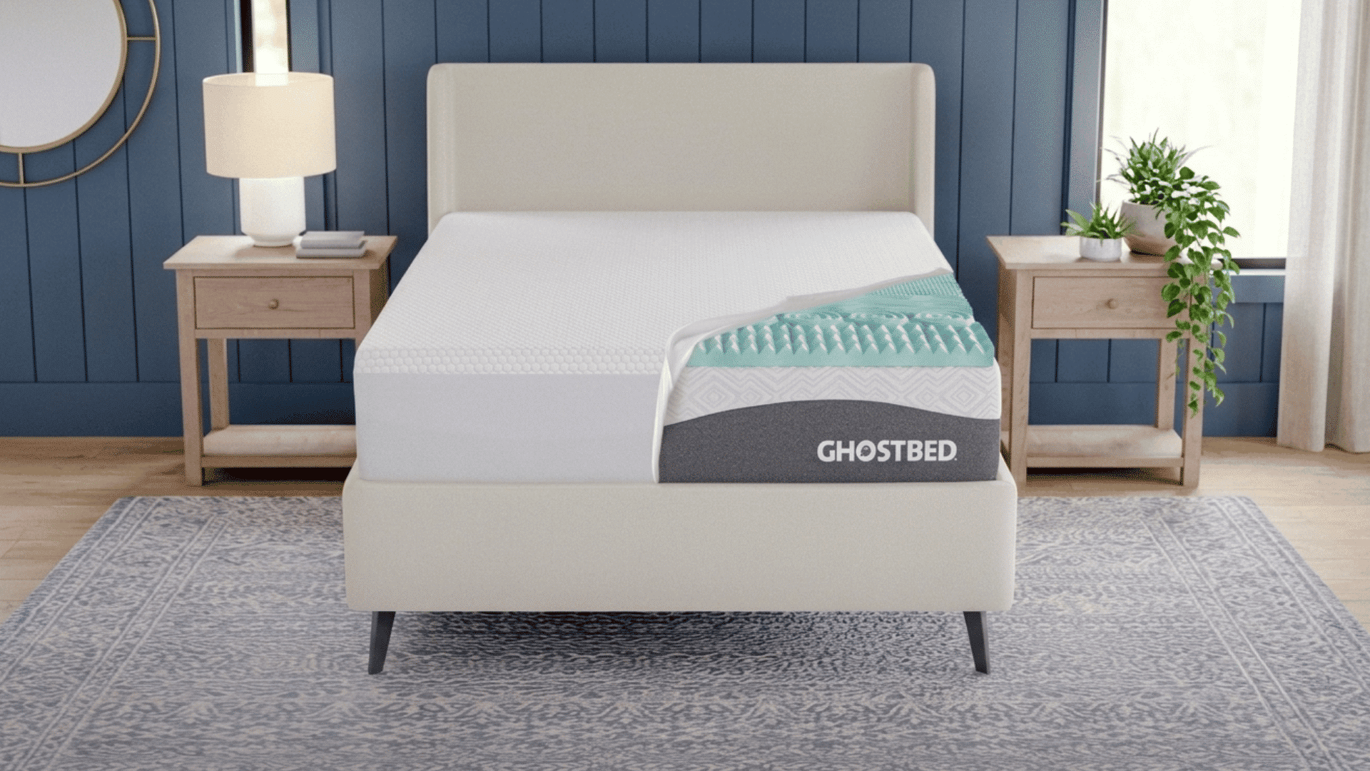 GhostBed mattress on a modern platform bed with pillows in a bright bedroom