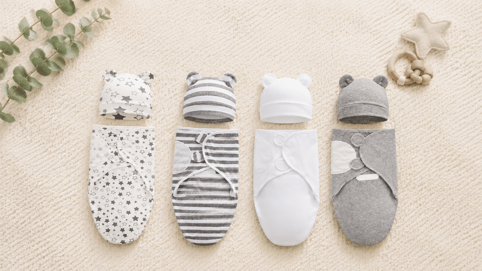 gray halo preemie swaddle displayed flat on a cream background with minimal decor