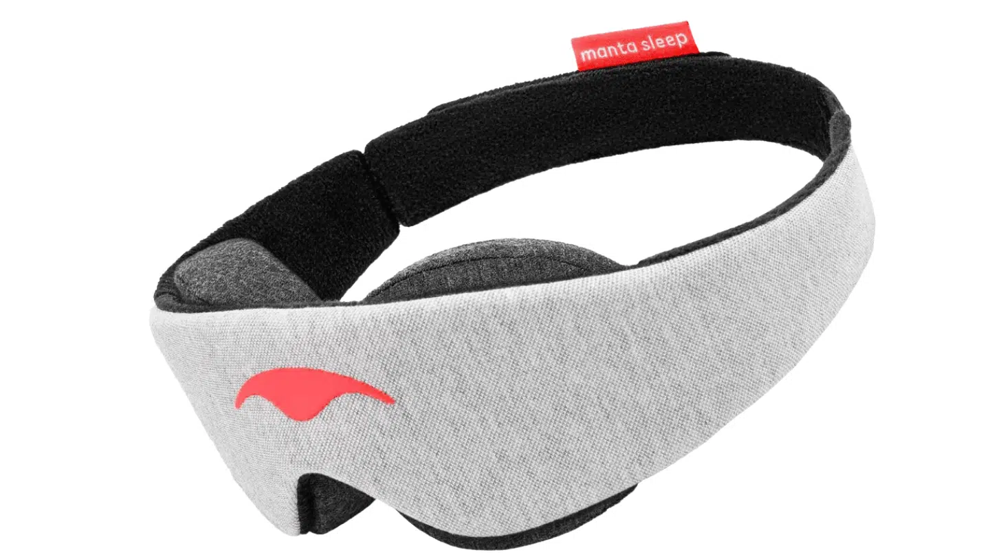 gray Manta Sleep mask with adjustable black head strap and plush eye cups on a mint green background