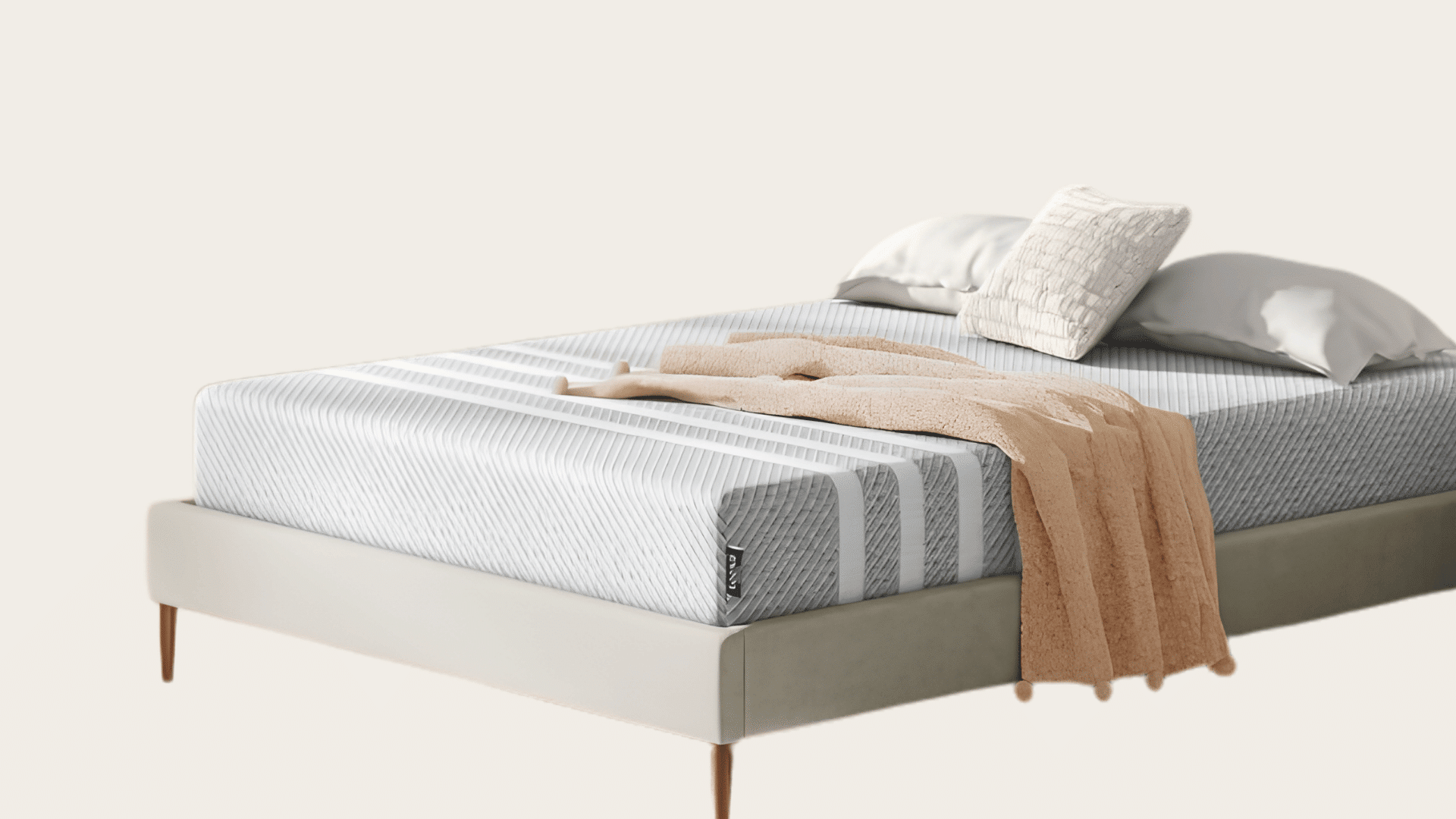 Leesa Original mattress on a neutral upholstered bed with layered pillows.