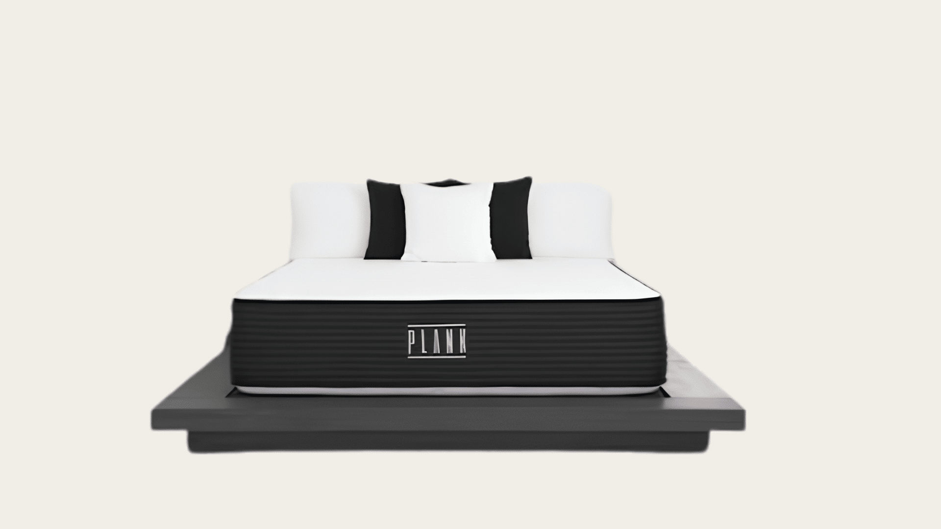 Plank Firm mattress on a low black platform bed with monochrome pillows.
