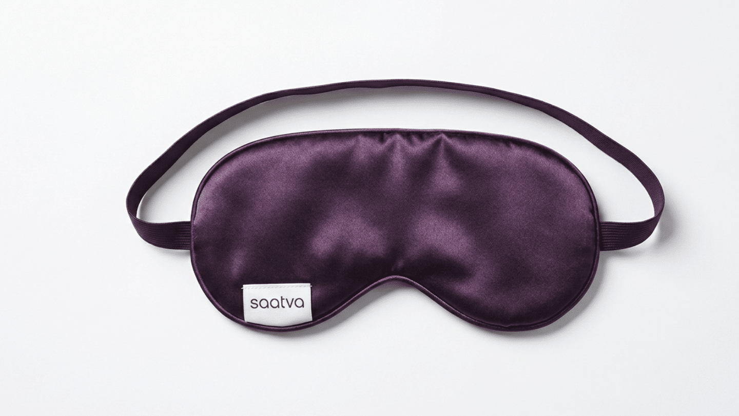 purple Saatva silk sleep mask with a slim elastic strap displayed on a clean white studio background
