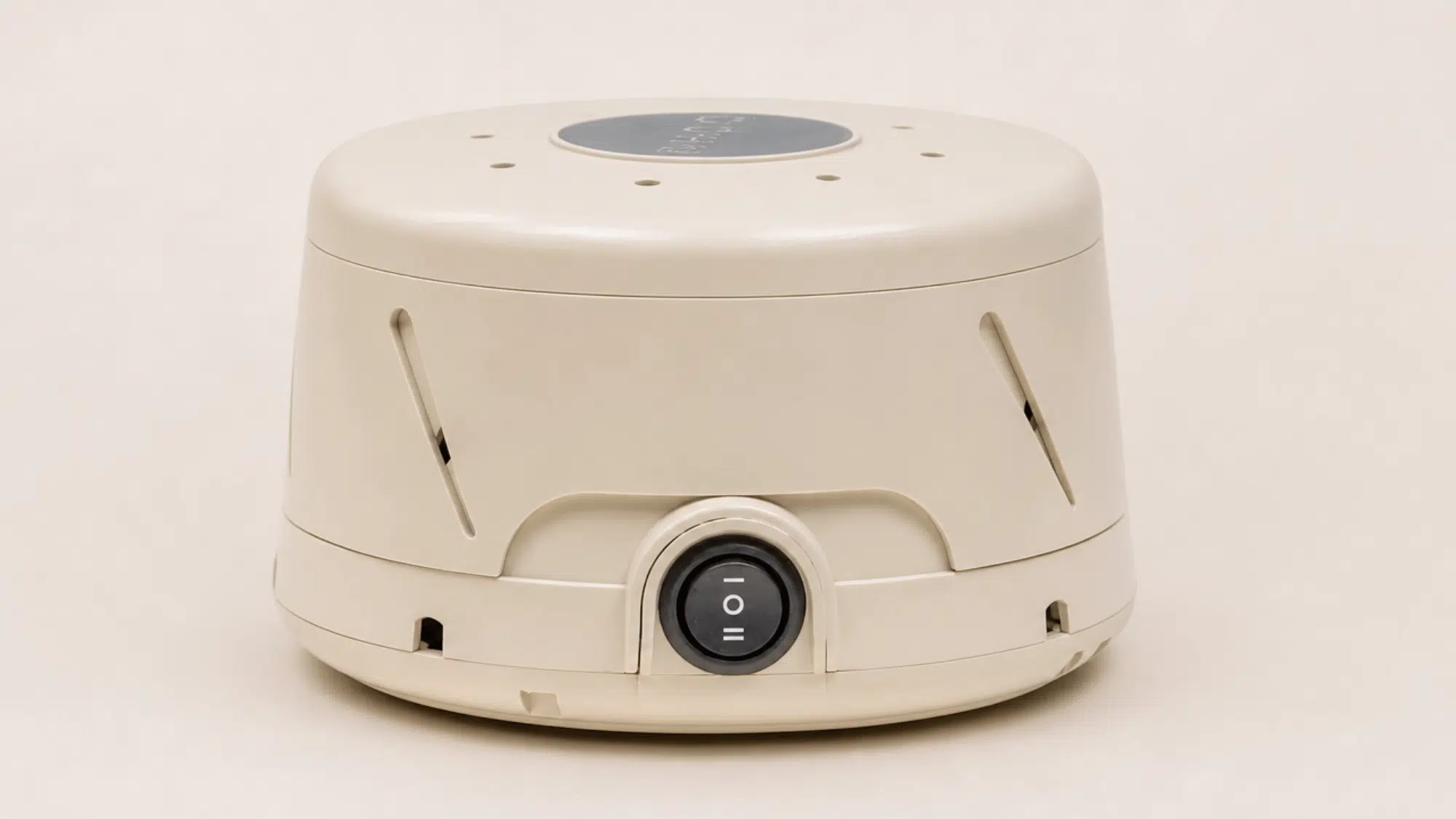 yogasleep dohm classic white noise machine with fan vents and control switch on a clean background