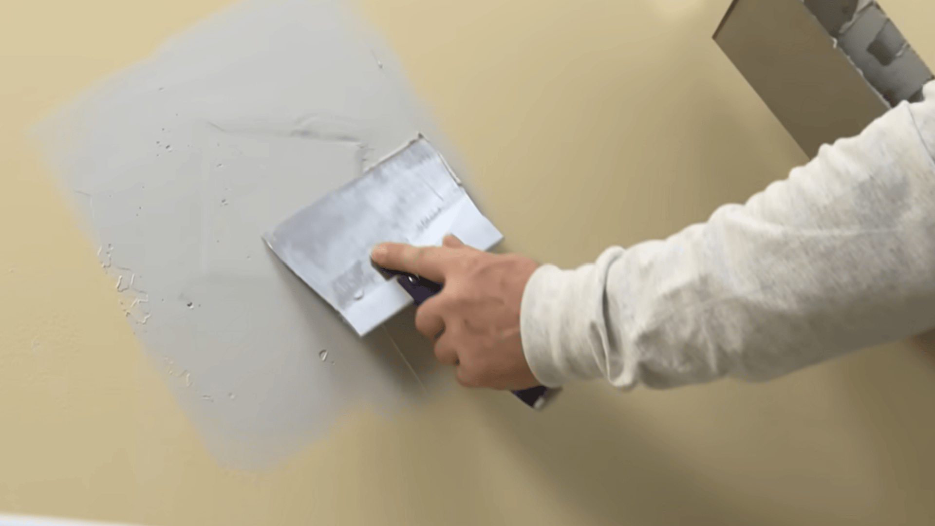 Smoothing joint compound around the patch for an even surface.