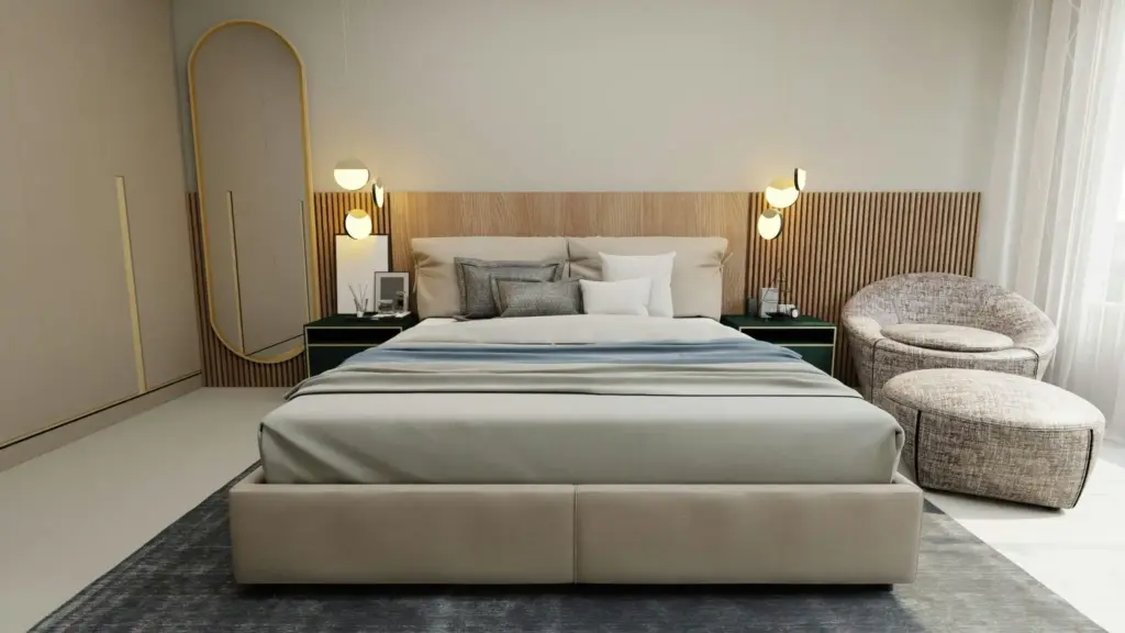Modern bedroom with beige bed, wooden headboard, and soft chairs beside a large mirror