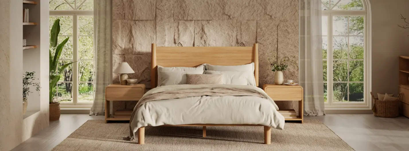 Cozy bedroom with light wooden bed and nightstands, large windows, neutral bedding, and potted plants