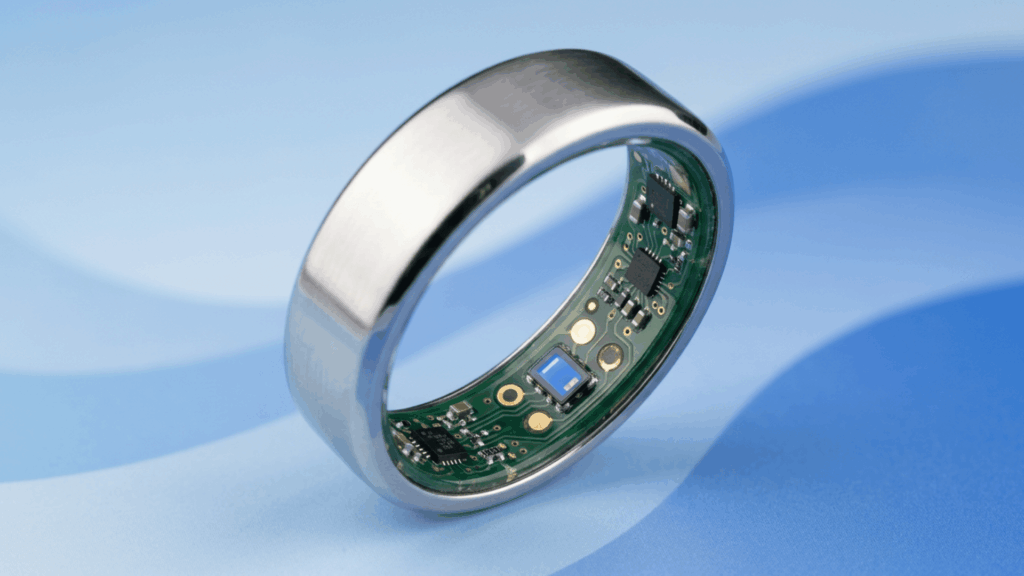 close up of a silver oura ring showing internal sensors and circuitry against a soft blue background
