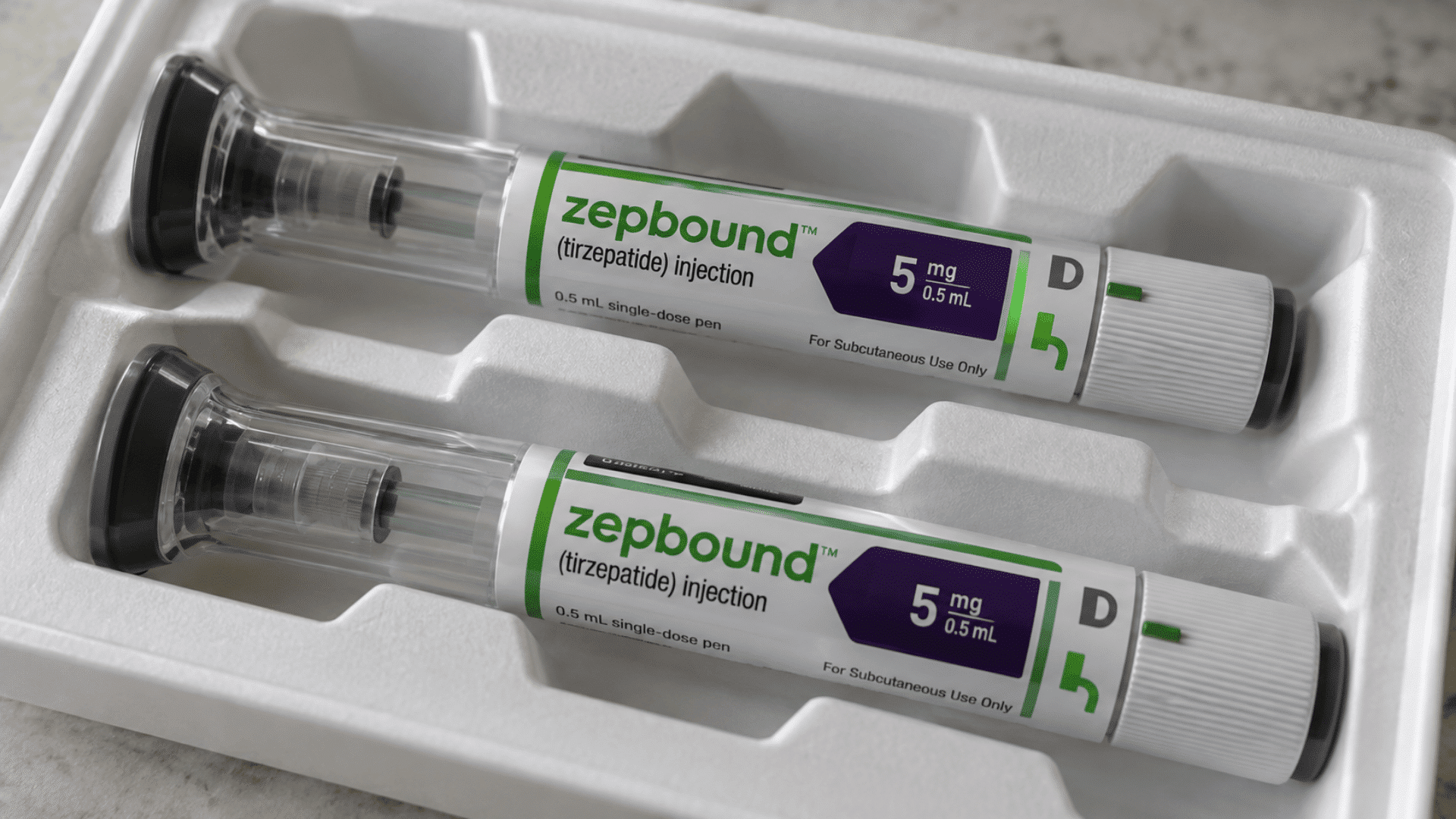 two Zepbound 5 mg injection pens arranged inside a white medication tray